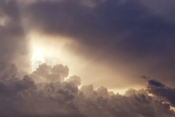 Sunlight breaking through dark clouds, symbolizing how to use AI without fear or confusion.