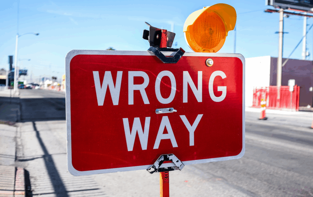 wrong-way-password-security Bright red 'Wrong Way' road sign with warning light — symbolizing danger and password system vulnerability